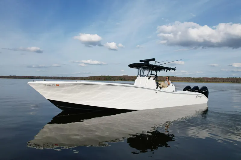  Yacht Photos Pics 2009 Yellowfin 36 Offshore boat on calm water under a partly cloudy sky.