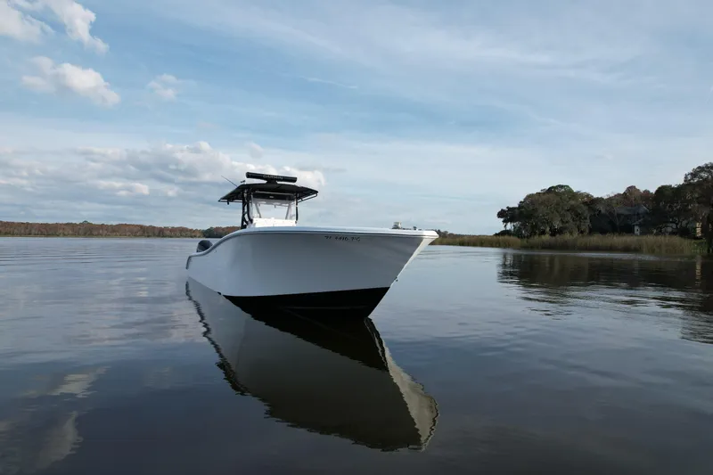  Yacht Photos Pics 2009 Yellowfin 36 Offshore boat on calm water under a partly cloudy sky.