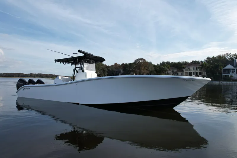  Yacht Photos Pics 2009 Yellowfin 36 Offshore boat on calm water, with scenic background.