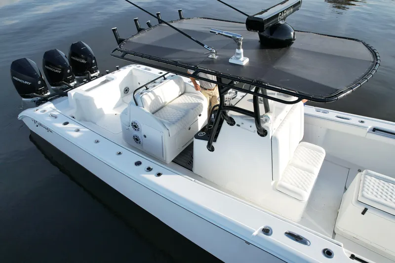  Yacht Photos Pics 2009 Yellowfin 36 Offshore boat with triple Mercury engines on calm water.