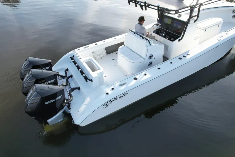  Yacht Photos Pics 2009 Yellowfin 36 Offshore boat with triple Mercury engines on calm water.