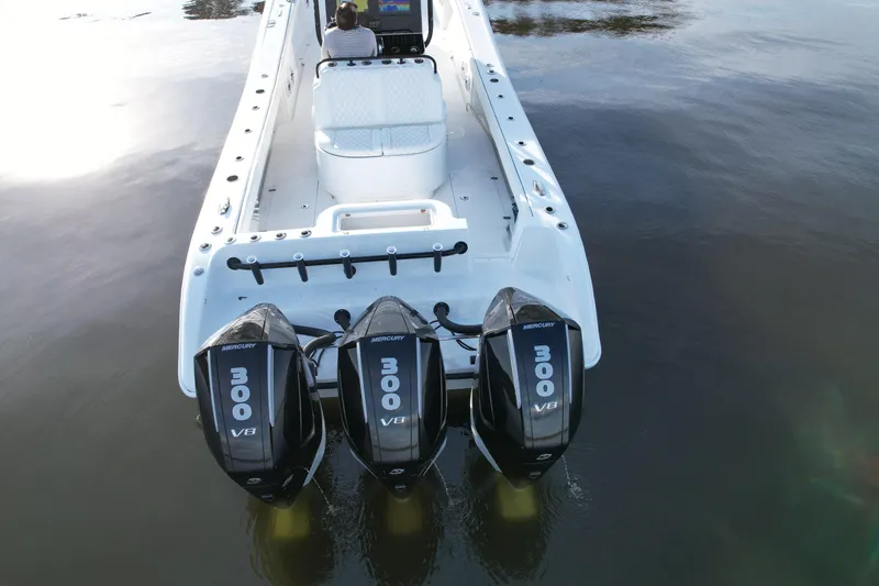  Yacht Photos Pics 2009 Yellowfin 36 Offshore boat with triple Mercury 300 V8 engines on calm water.