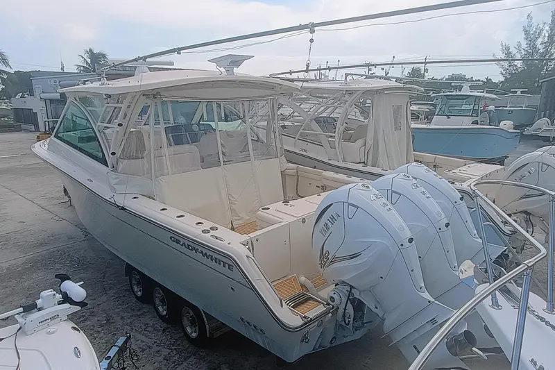 375-712 Used Yacht Photos Pics 2021 Grady-White Freedom 375 boat with triple Yamaha engines, docked in a marina.