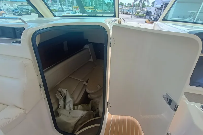 375-712 Used Yacht Photos Pics 2021 Grady-White Freedom 375 cabin interior with open door, showcasing seating and storage.