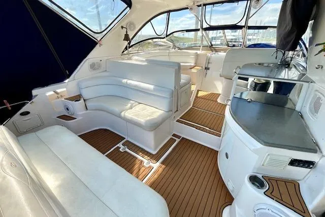"just One Mohr" Yacht Photos Pics Luxurious interior of 2005 Regal Commodore 4260 yacht with white seating and wood flooring.