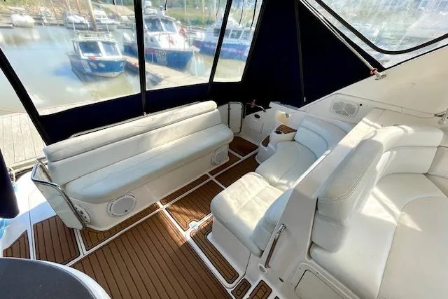 "just One Mohr" Yacht Photos Pics 2005 Regal Commodore 4260 yacht interior with white seating and wood flooring.