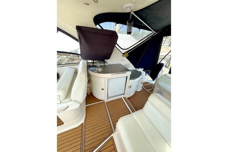 "just One Mohr" Yacht Photos Pics Interior of 2005 Regal Commodore 4260 yacht with white seating and wooden flooring.