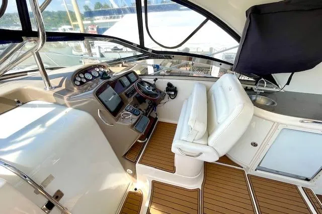 "just One Mohr" Yacht Photos Pics 2005 Regal Commodore 4260 yacht cockpit with modern controls and white seating.