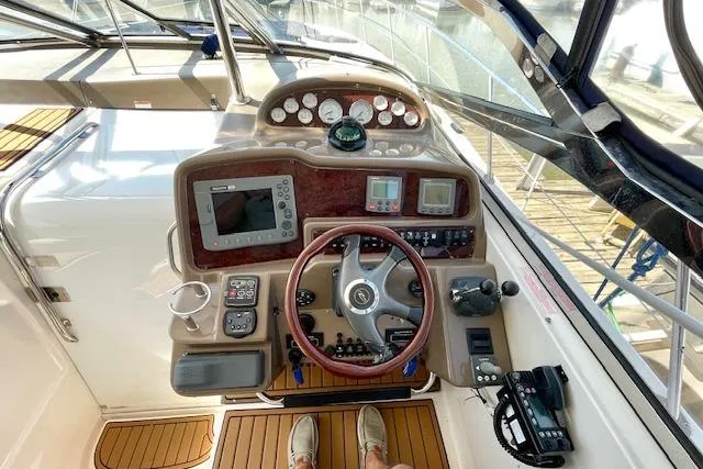 "just One Mohr" Yacht Photos Pics Helm of 2005 Regal Commodore 4260 yacht with navigation instruments and steering wheel.