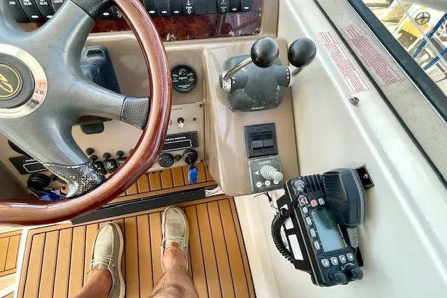 "just One Mohr" Yacht Photos Pics 2005 Regal Commodore 4260 helm with steering wheel, controls, and radio equipment.