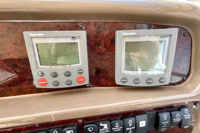 "just One Mohr" Yacht Photos Pics Control panel of 2005 Regal Commodore 4260 with Raymarine displays and switches.