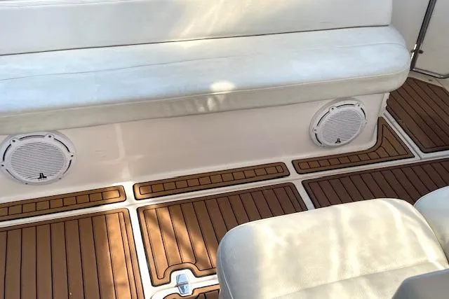 "just One Mohr" Yacht Photos Pics 2005 Regal Commodore 4260 boat interior with cushioned seating and wood-patterned flooring.