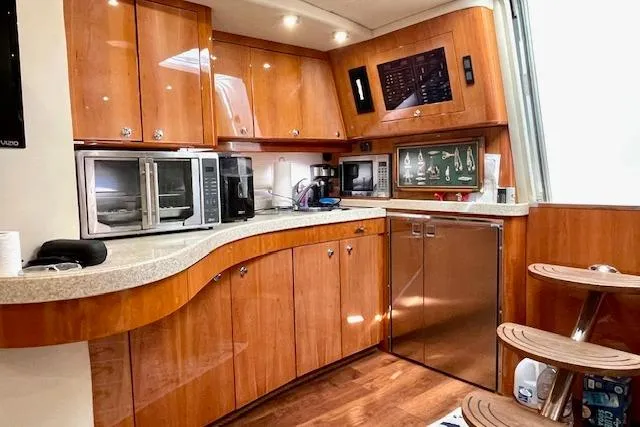 "just One Mohr" Yacht Photos Pics Luxurious 2005 Regal Commodore 4260 yacht kitchen with wood cabinetry and modern appliances.