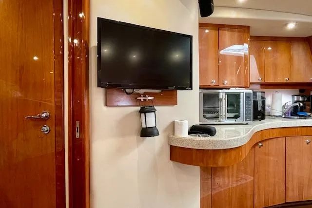 "just One Mohr" Yacht Photos Pics Interior of 2005 Regal Commodore 4260 yacht with TV and kitchen appliances.
