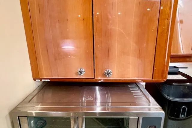 "just One Mohr" Yacht Photos Pics Wooden cabinet and stainless steel appliance in 2005 Regal Commodore 4260 yacht interior.