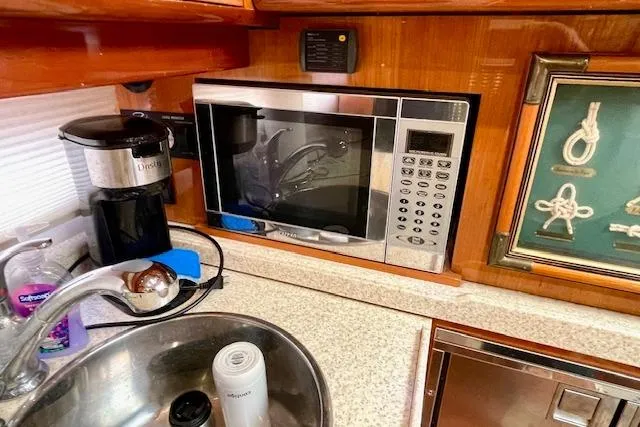 "just One Mohr" Yacht Photos Pics 2005 Regal Commodore 4260 yacht kitchen with microwave, coffee maker, and sink.