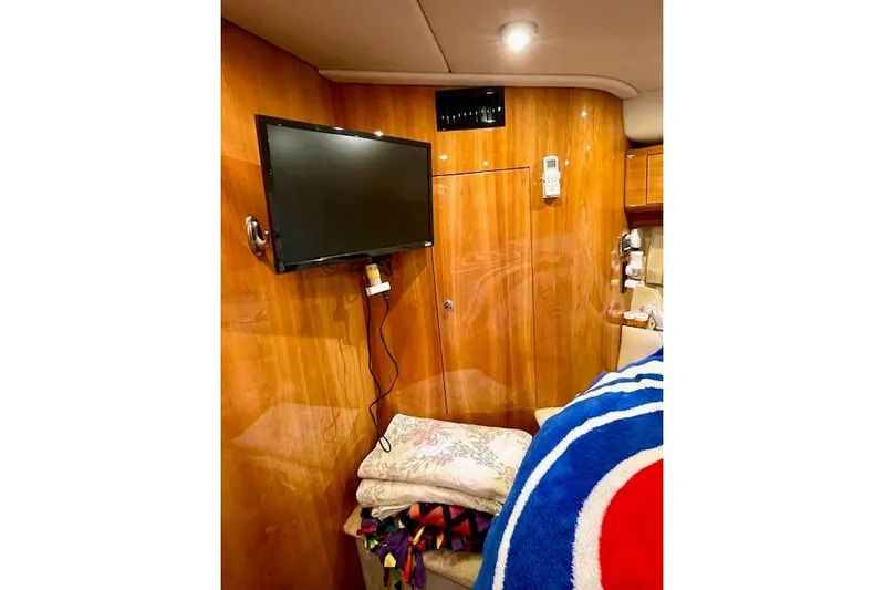 "just One Mohr" Yacht Photos Pics Interior of 2005 Regal Commodore 4260 yacht with TV and cozy bedding.