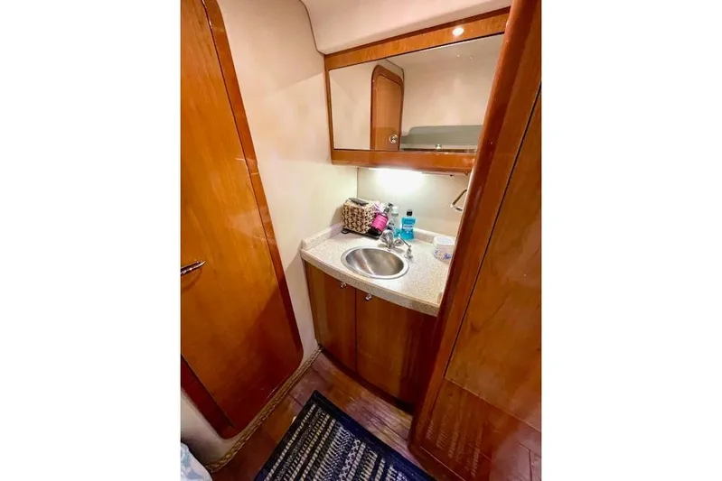 "just One Mohr" Yacht Photos Pics 2005 Regal Commodore 4260 yacht bathroom with wooden cabinetry and compact sink.