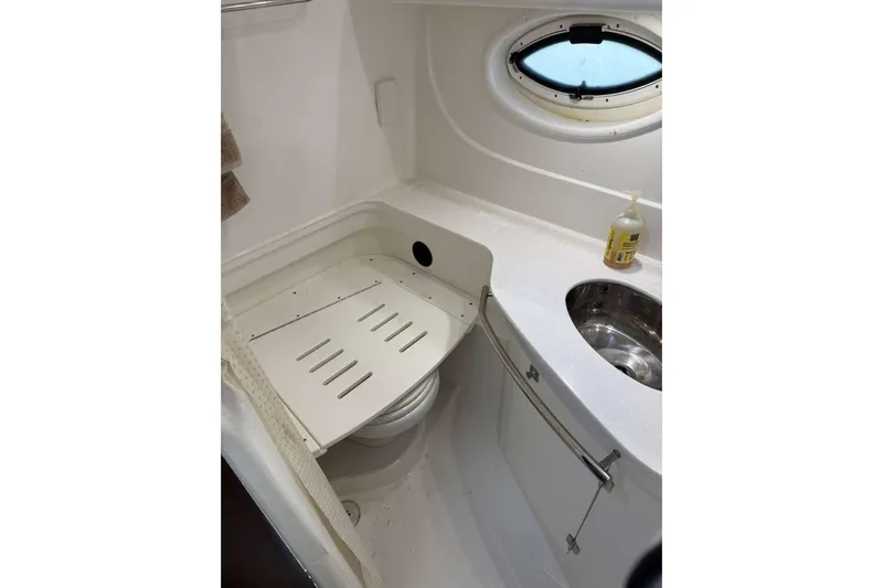  Yacht Photos Pics 2018 Monterey 335 Sport Yacht bathroom with sink, porthole, and storage.