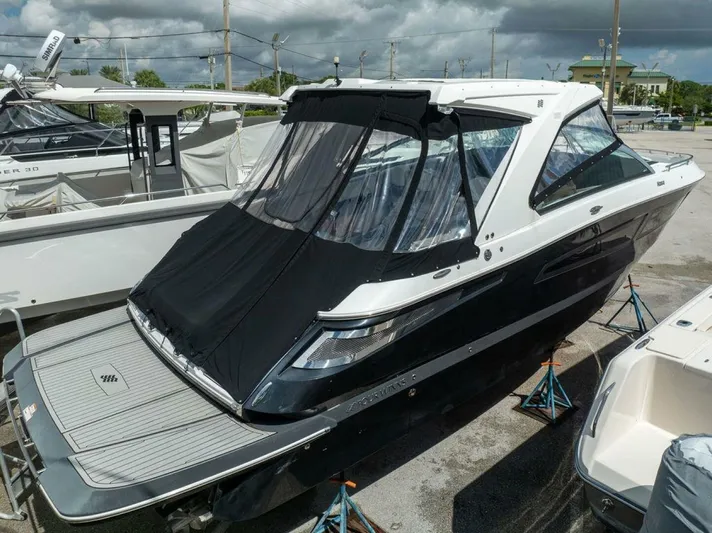 Yacht Photos Pics 2020 Four Winns H350 boat with black canopy, docked outdoors.