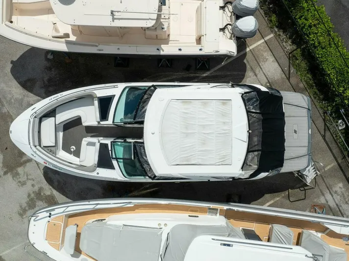  Yacht Photos Pics Aerial view of a 2020 Four Winns H350 yacht docked among other boats.