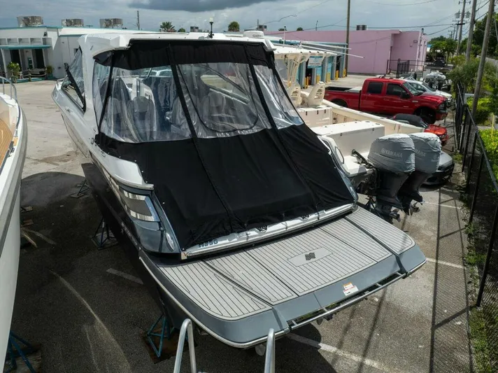  Yacht Photos Pics 2020 Four Winns H350 boat with covered deck, parked outdoors.