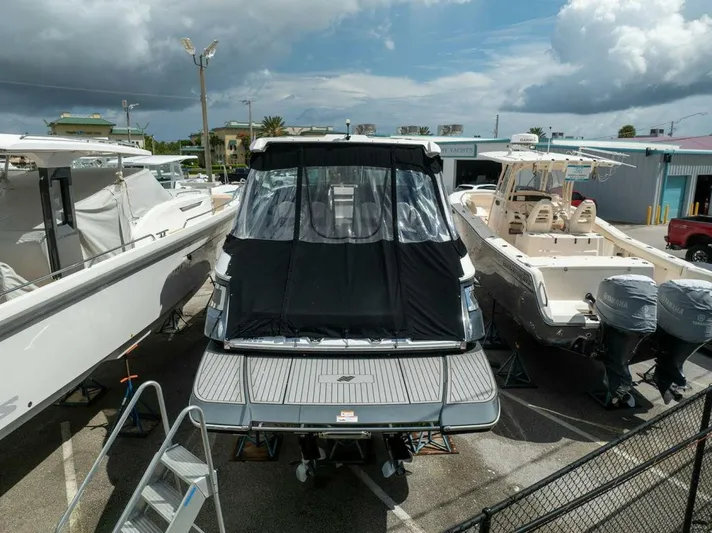  Yacht Photos Pics 2020 Four Winns H350 boat docked with cover, surrounded by other boats.
