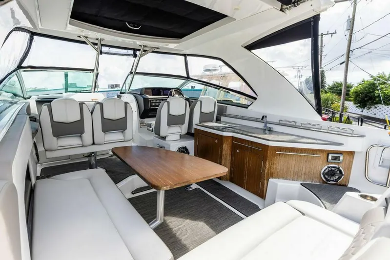  Yacht Photos Pics Luxurious 2020 Four Winns H350 boat interior with modern seating and wooden table.