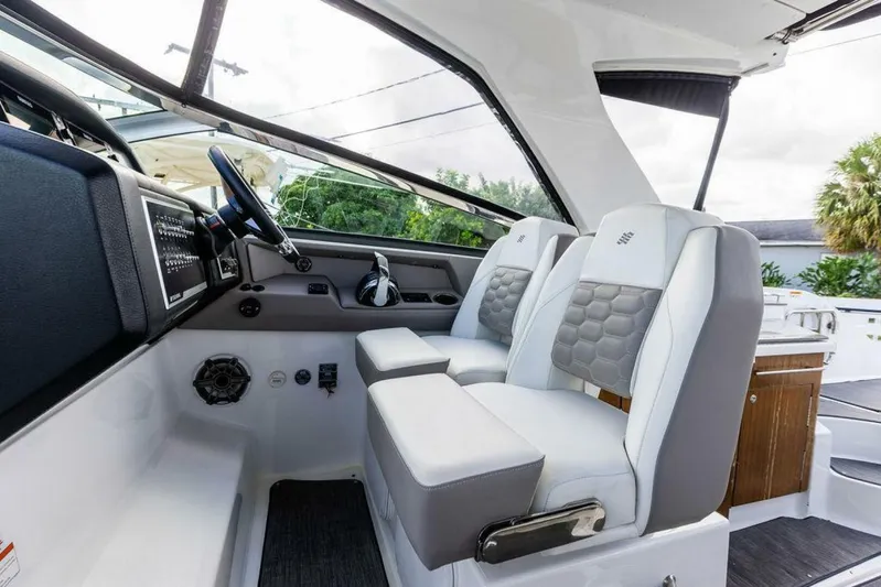  Yacht Photos Pics 2020 Four Winns H350 boat interior with modern helm and cushioned seating.