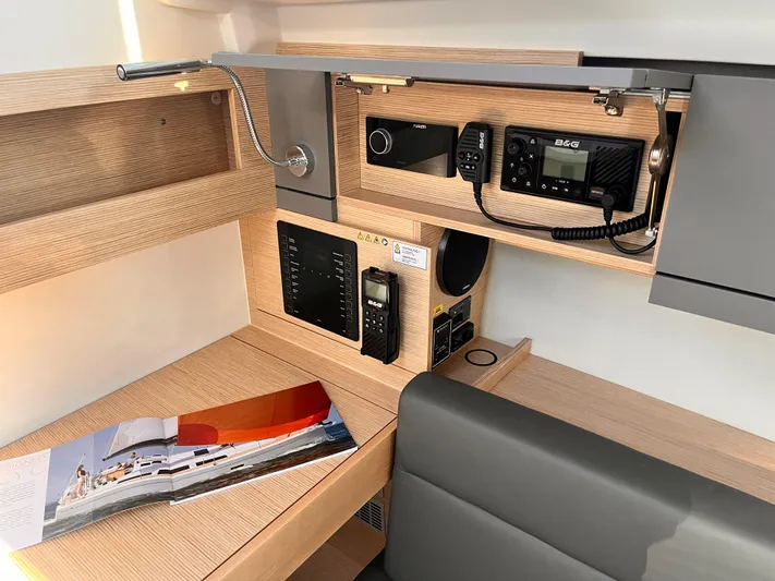 348 Sea Yacht Photos Pics Modern navigation station in 2026 Hanse 348 yacht with communication equipment and brochure.