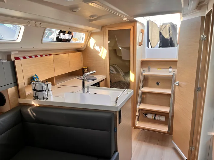 348 Sea Yacht Photos Pics Modern interior of 2026 Hanse 348 sailboat, featuring sleek kitchen and cozy seating area.