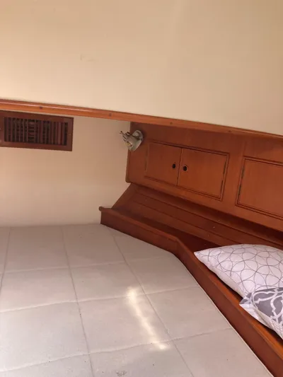 Tatosh Yacht Photos Pics Cozy cabin interior of 1998 Grand Banks 43 Eastbay FB with wooden accents and pillow.