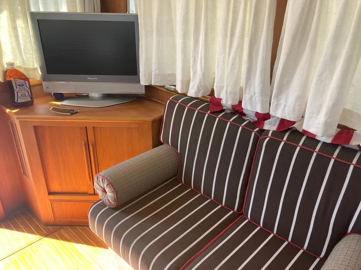 Tatosh Yacht Photos Pics Interior of 1998 Grand Banks 43 Eastbay FB with striped sofa and TV.