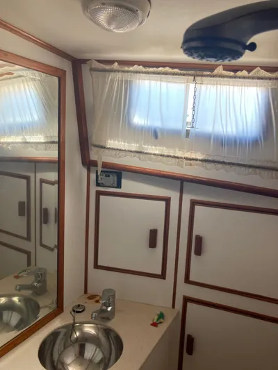 Tatosh Yacht Photos Pics Bathroom interior of 1998 Grand Banks 43 Eastbay FB yacht with sink and mirror.