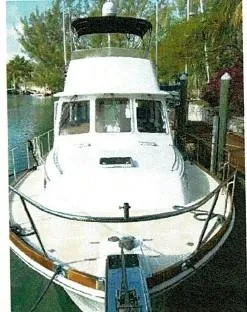 Tatosh Yacht Photos Pics 1998 Grand Banks 43 Eastbay FB yacht docked, featuring a sleek white exterior and flybridge.