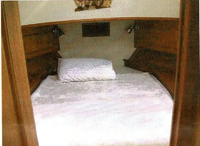 Tatosh Yacht Photos Pics Cozy cabin bed in 1998 Grand Banks 43 Eastbay FB yacht, featuring wooden accents and white bedding.