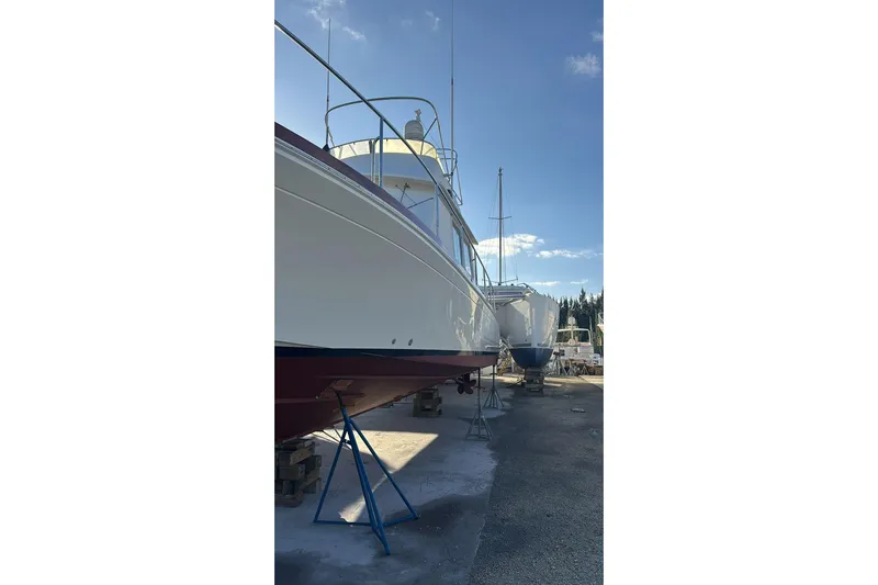 Tatosh Yacht Photos Pics 1998 Grand Banks 43 Eastbay FB yacht on dry dock under clear blue sky.