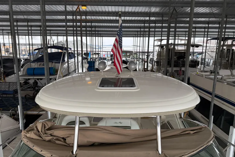  Yacht Photos Pics 2006 Sea Ray 40 Sundancer docked in marina with American flag displayed.