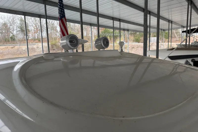  Yacht Photos Pics 2006 Sea Ray 40 Sundancer boat under covered dock with speakers and American flag.