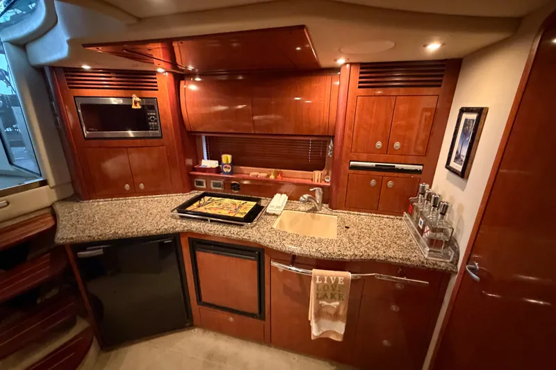  Yacht Photos Pics Luxurious 2006 Sea Ray 40 Sundancer yacht kitchen with granite countertops and wood cabinetry.