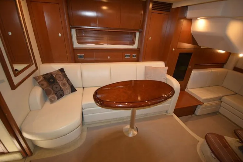  Yacht Photos Pics Luxurious interior of 2006 Sea Ray 40 Sundancer yacht with elegant seating and wooden table.