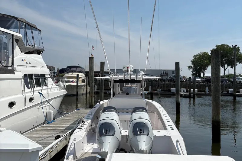  Yacht Photos Pics 2009 Venture 34 CC boat docked at marina with twin engines and clear sky.