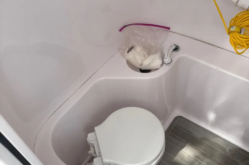  Yacht Photos Pics Compact bathroom in 2009 Venture 34 CC boat with toilet and storage space.