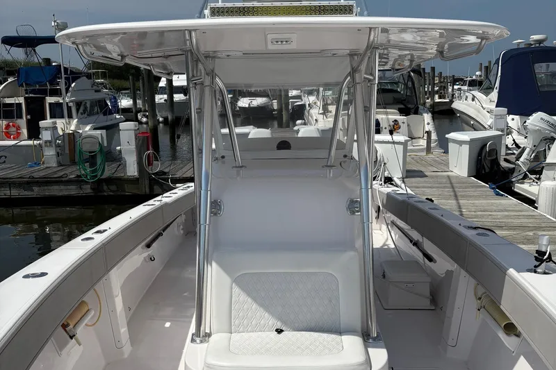  Yacht Photos Pics 2009 Venture 34 CC boat docked at marina, featuring spacious deck and modern design.