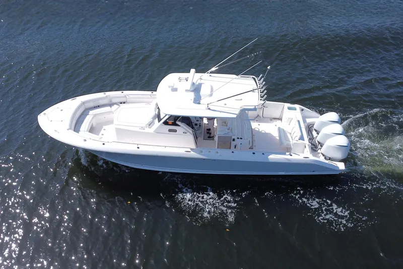 Perseverance Yacht Photos Pics 2019 Pursuit S 368 Sport boat cruising on open water, aerial view.
