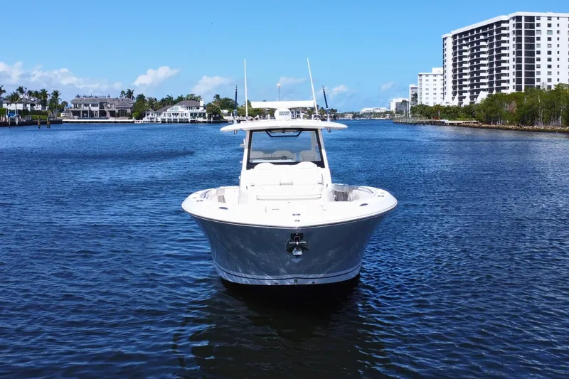 Perseverance Yacht Photos Pics 2019 Pursuit S 368 Sport boat on calm water with cityscape background.