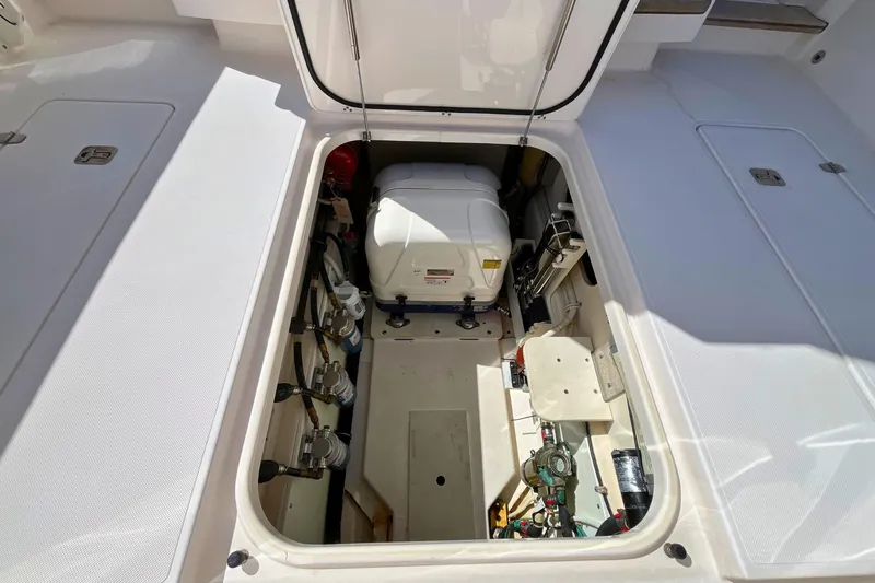 Perseverance Yacht Photos Pics 2019 Pursuit S 368 Sport boat engine compartment, showcasing equipment and storage space.