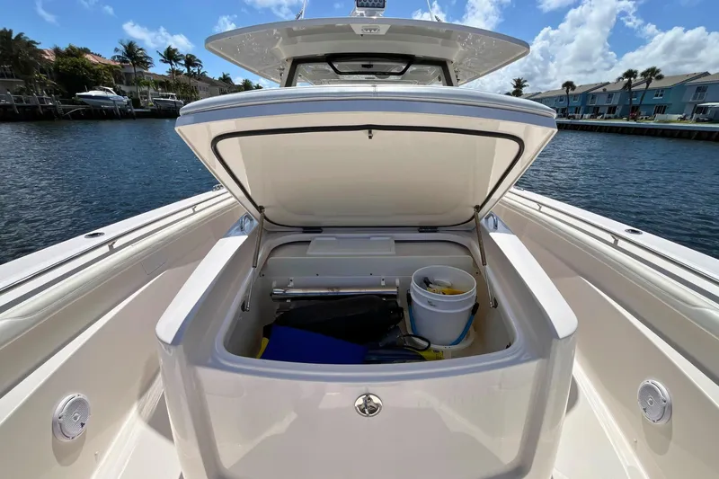 Perseverance Yacht Photos Pics 2019 Pursuit S 368 Sport boat with open storage compartment, dockside view.