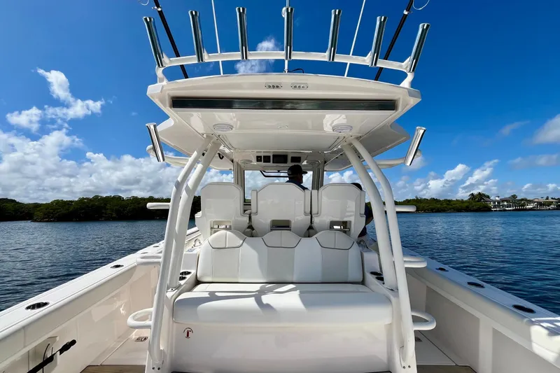 Perseverance Yacht Photos Pics 2019 Pursuit S 368 Sport boat interior with seating, rod holders, and scenic water view.