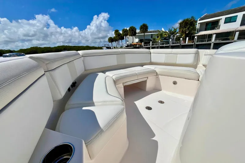 Perseverance Yacht Photos Pics 2019 Pursuit S 368 Sport boat with spacious white seating under blue sky.